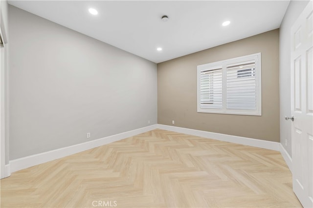 spare room with baseboards and recessed lighting