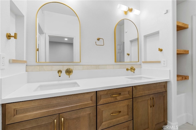 bathroom featuring a sink and double vanity