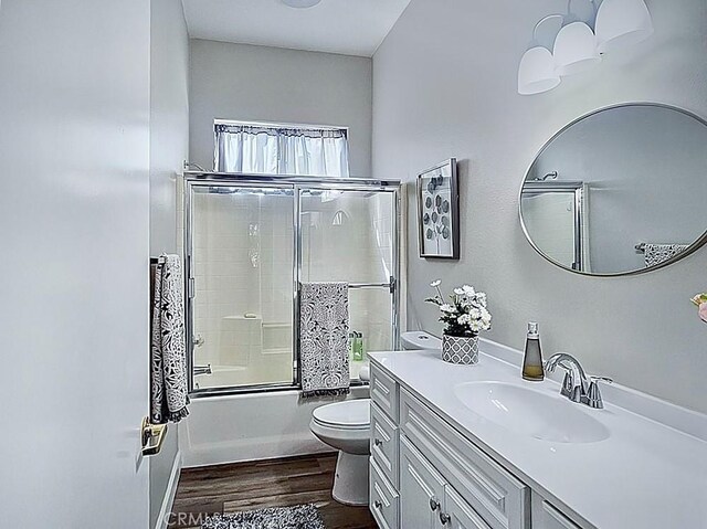 68262 Pasada Rd, Cathedral City, CA 92234 - bathroom featuring wood finished floors, vanity, and combined bath / shower with glass door