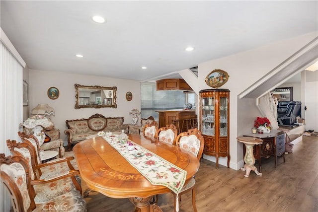 dining area with light wood-style floors and recessed lighting