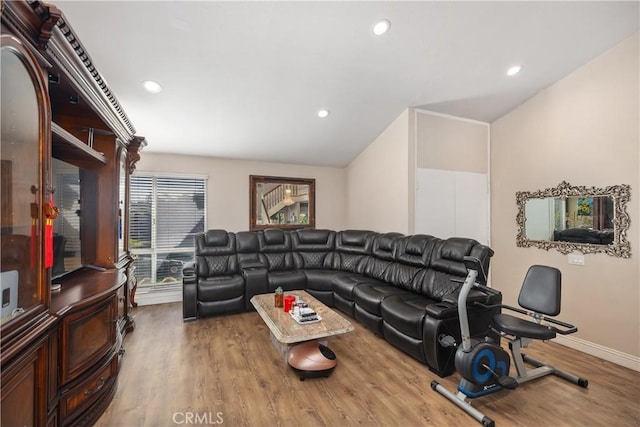 living room with recessed lighting, baseboards, and wood finished floors