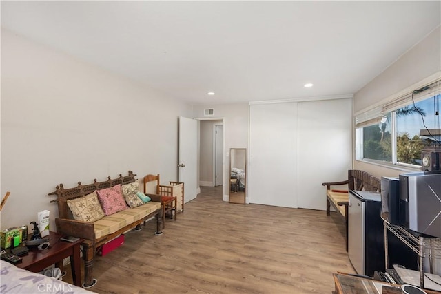 living area featuring light wood-style floors, visible vents, and recessed lighting