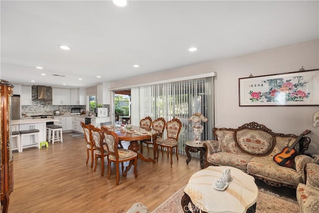 dining space featuring recessed lighting and light wood-style flooring