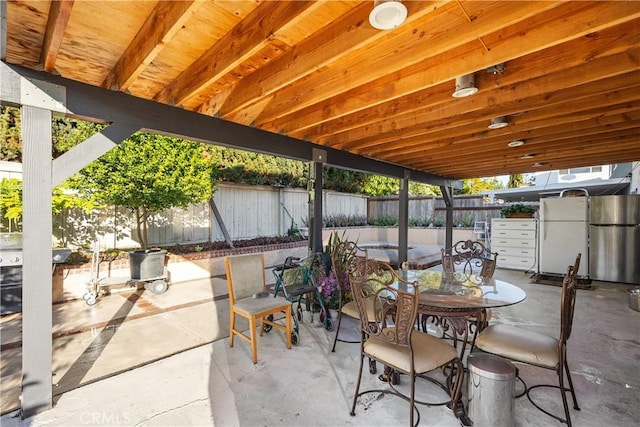 view of patio with outdoor dining area and a fenced backyard