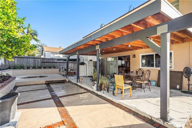 view of patio with fence and outdoor dining space