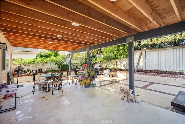 view of patio with a fenced backyard and outdoor dining area