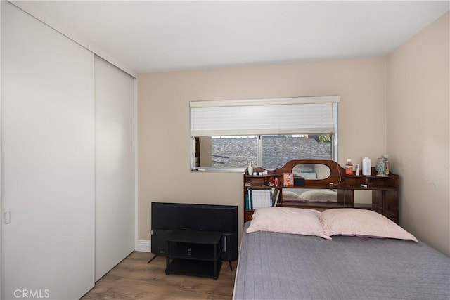 bedroom with a closet and wood finished floors