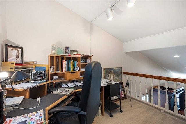 office space featuring lofted ceiling, rail lighting, and carpet flooring