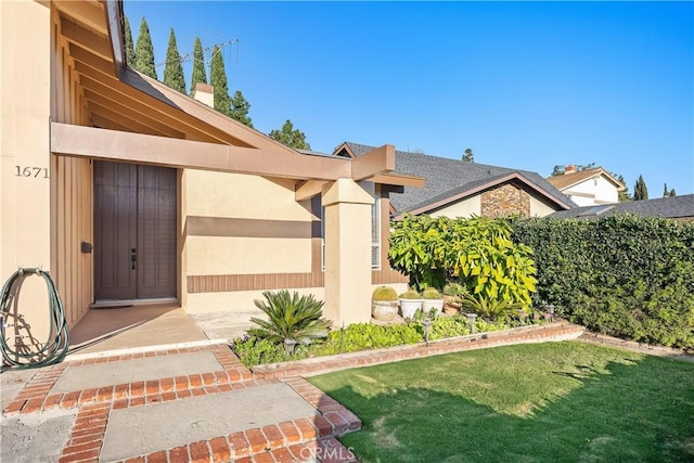 exterior space featuring a lawn and stucco siding