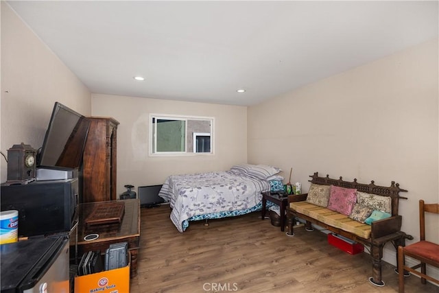 bedroom featuring wood finished floors and recessed lighting