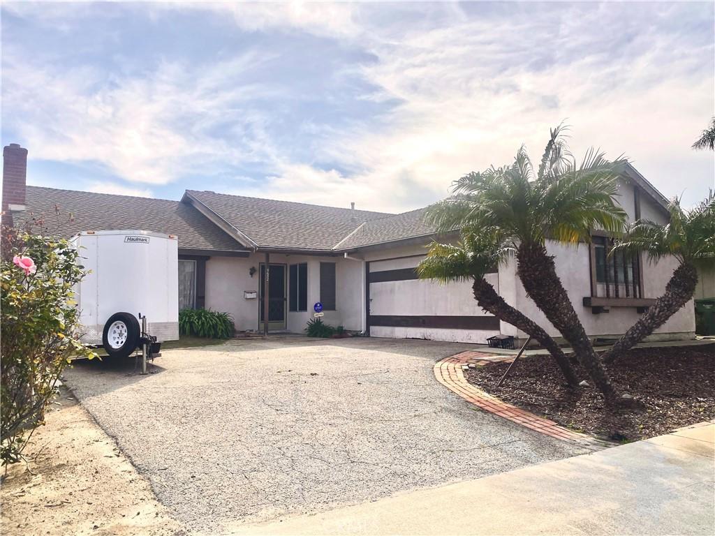 single story home with stucco siding, an attached garage, roof with shingles, and driveway