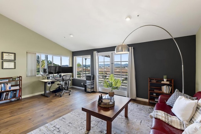 home office with lofted ceiling, plenty of natural light, wood finished floors, and baseboards