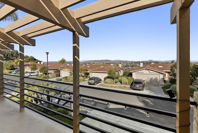 balcony featuring a residential view and a pergola