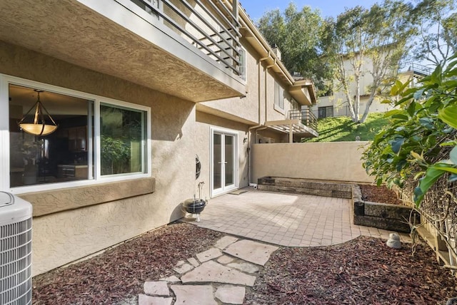 view of patio / terrace with fence, central AC, and french doors