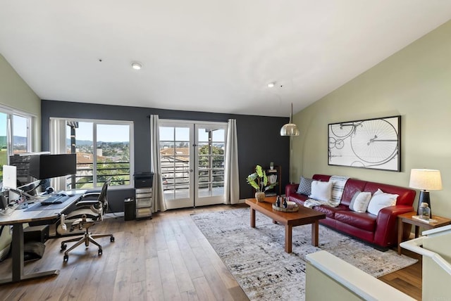 living area with lofted ceiling and wood finished floors