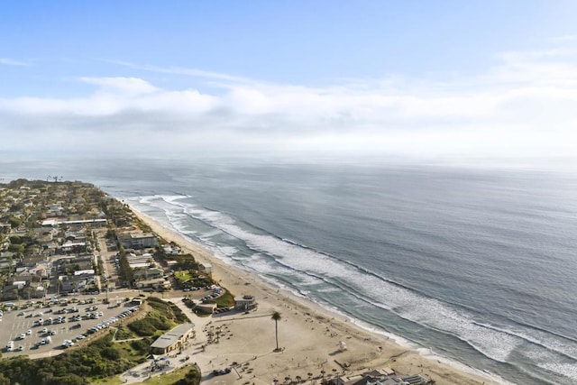 drone / aerial view featuring a water view and a view of the beach