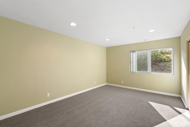 empty room with carpet, recessed lighting, visible vents, and baseboards