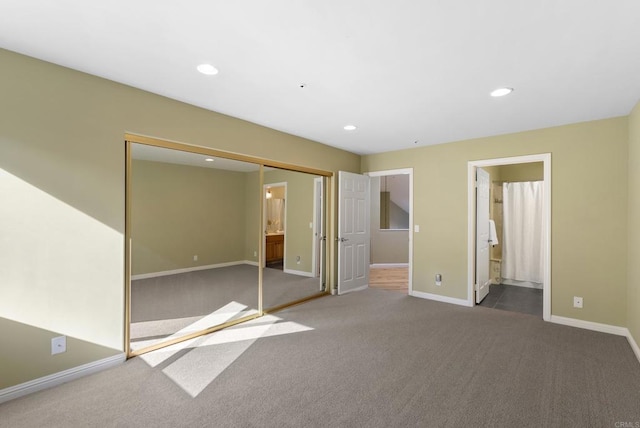 unfurnished bedroom with carpet floors, baseboards, a closet, and recessed lighting