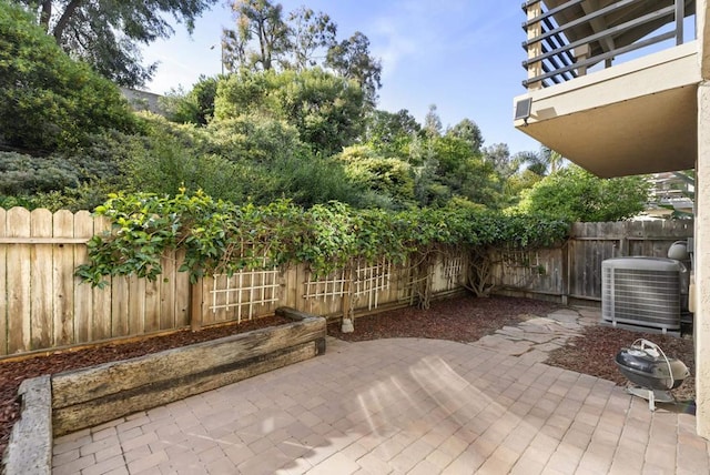 view of patio / terrace with a balcony, a fenced backyard, and cooling unit