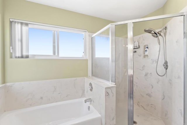 bathroom featuring a stall shower and a bath