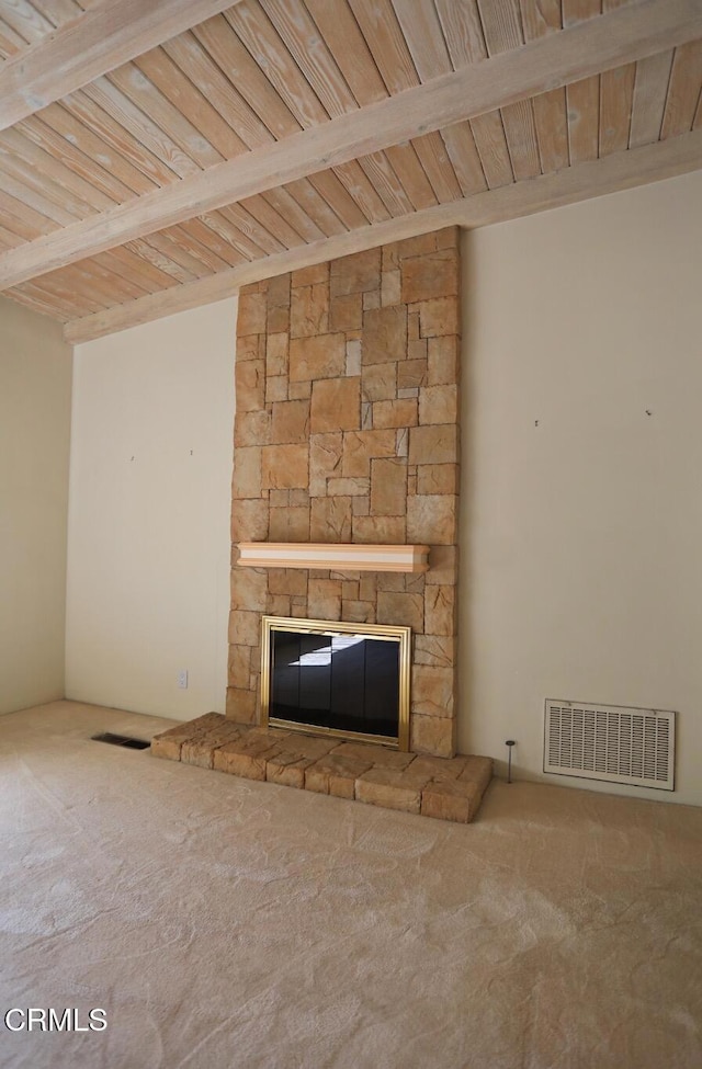 unfurnished living room featuring a stone fireplace, carpet, and visible vents