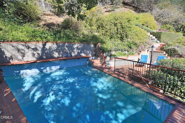 view of swimming pool with a fenced in pool