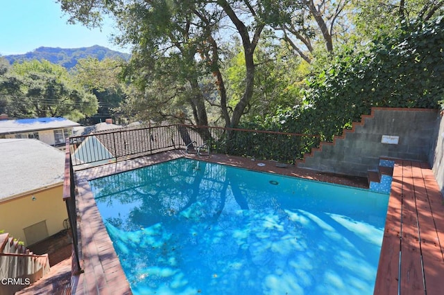 outdoor pool featuring a deck with mountain view