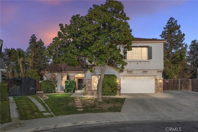 view of front of house with brick siding, stucco siding, concrete driveway, an attached garage, and fence