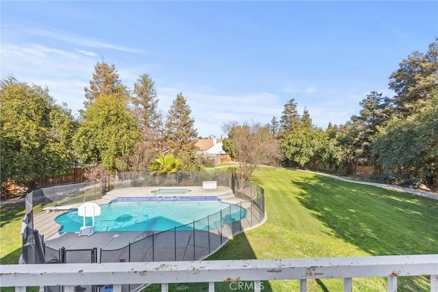 view of swimming pool with an in ground hot tub, fence, a fenced in pool, and a yard