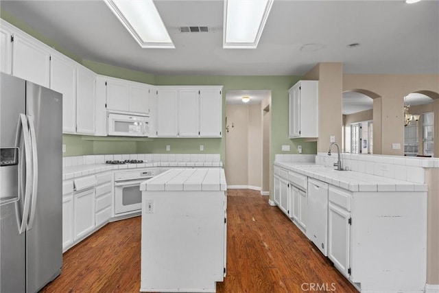 kitchen featuring white appliances and white cabinetry