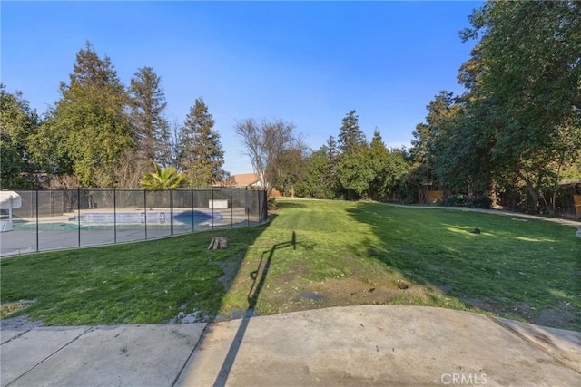 view of yard with a fenced in pool and fence