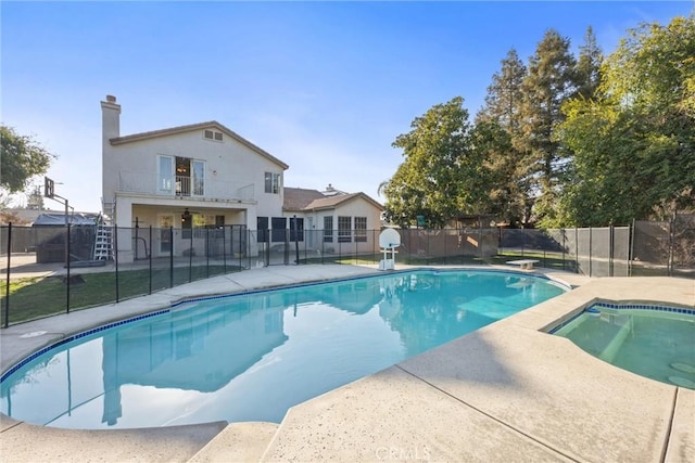 view of pool with fence, a diving board, a fenced in pool, and a patio