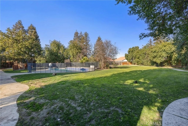 view of yard with a fenced in pool and fence