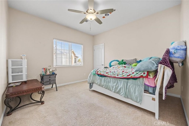 carpeted bedroom with ceiling fan and baseboards