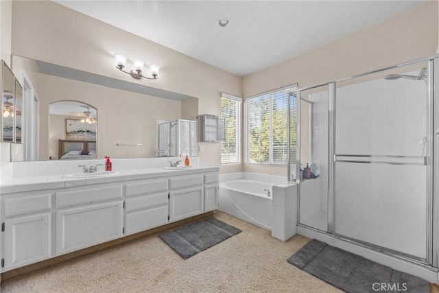 full bathroom featuring a garden tub, double vanity, connected bathroom, a sink, and a shower stall