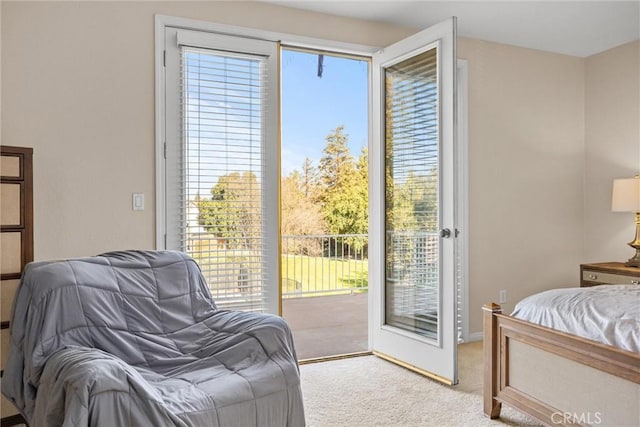 bedroom with access to exterior and light colored carpet