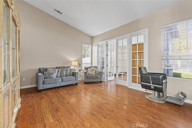 sitting room featuring vaulted ceiling, french doors, wood finished floors, and visible vents