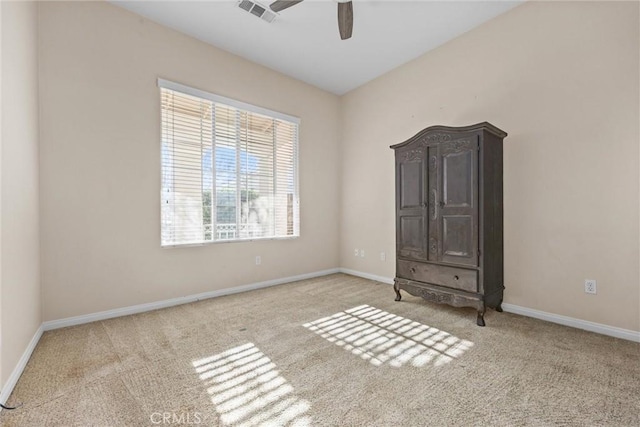 unfurnished bedroom with light carpet, a ceiling fan, visible vents, and baseboards