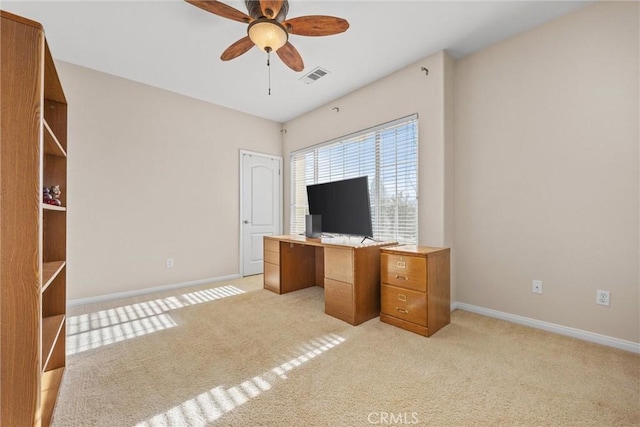 unfurnished office with light carpet, ceiling fan, visible vents, and baseboards