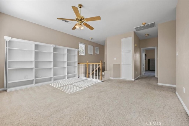 empty room featuring light colored carpet, visible vents, and baseboards