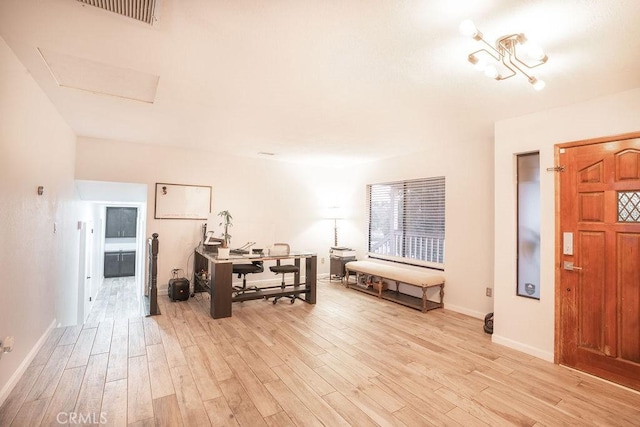 interior space featuring visible vents, light wood-style flooring, and baseboards