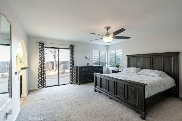 bedroom with light carpet, access to outside, baseboards, and a ceiling fan