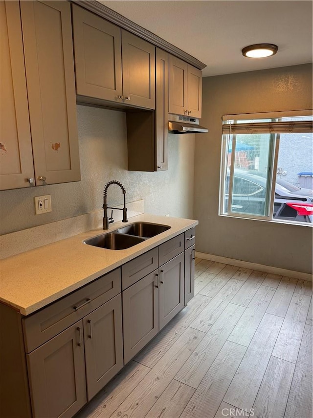 123 E Alondra Blvd, Compton, CA 90220 - kitchen featuring gray cabinetry, baseboards, light wood finished floors, a sink, and light countertops