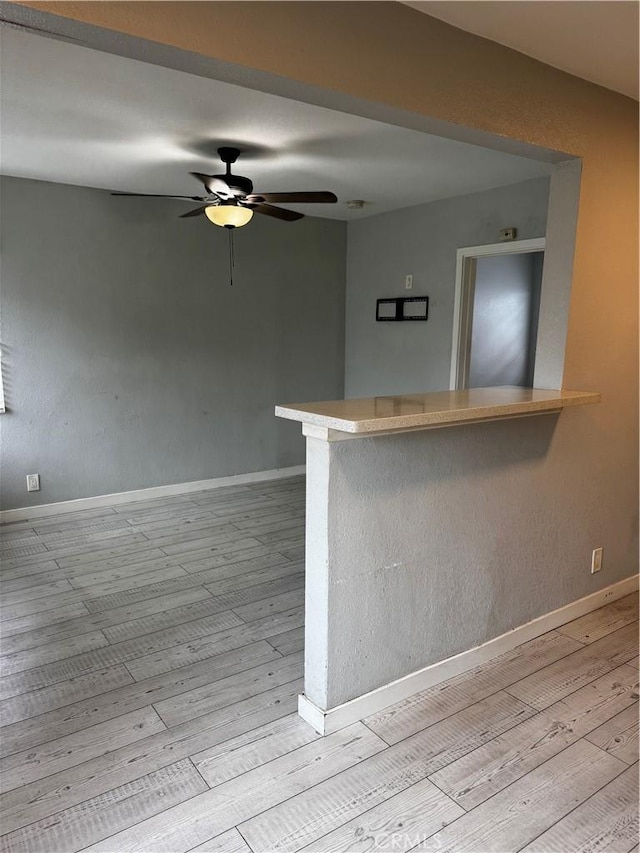 123 E Alondra Blvd, Compton, CA 90220 - kitchen featuring baseboards, a peninsula, light wood-style flooring, and ceiling fan