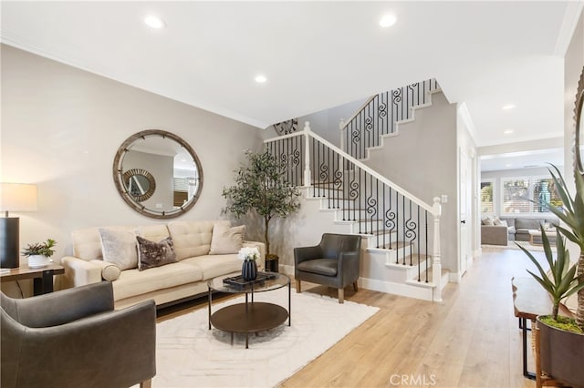 living room with light wood-style flooring, stairs, ornamental molding, and recessed lighting