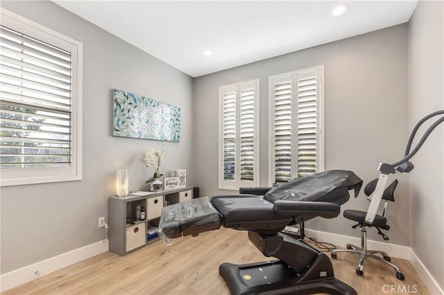 workout area featuring light wood-type flooring, baseboards, and recessed lighting