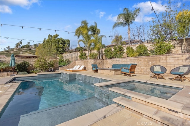 view of swimming pool featuring a patio area, a fenced backyard, and a pool with connected hot tub