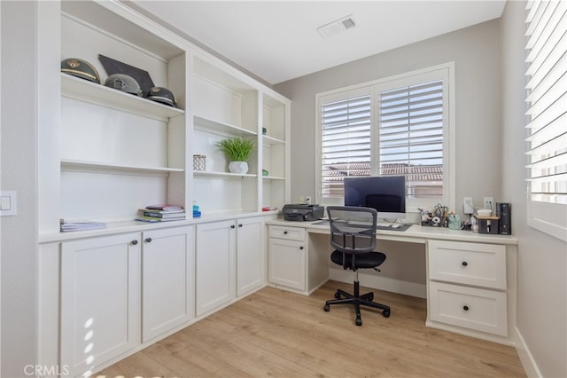 office featuring light wood-type flooring and visible vents