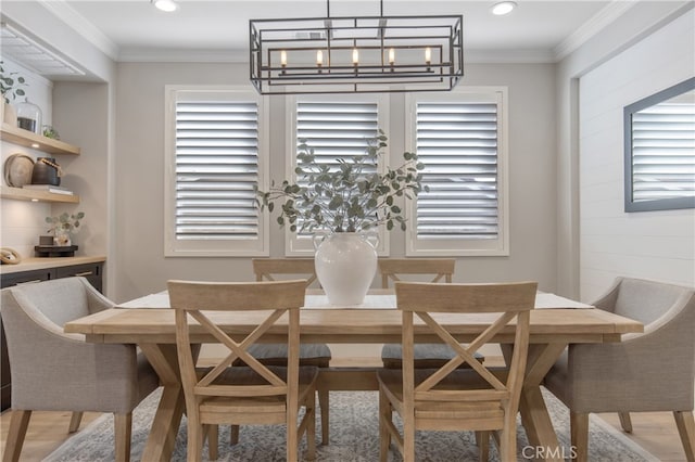 dining area featuring recessed lighting, plenty of natural light, crown molding, and wood finished floors