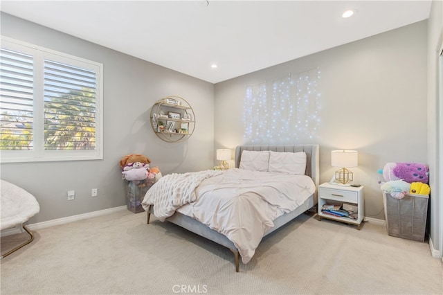 bedroom with baseboards, recessed lighting, and light colored carpet